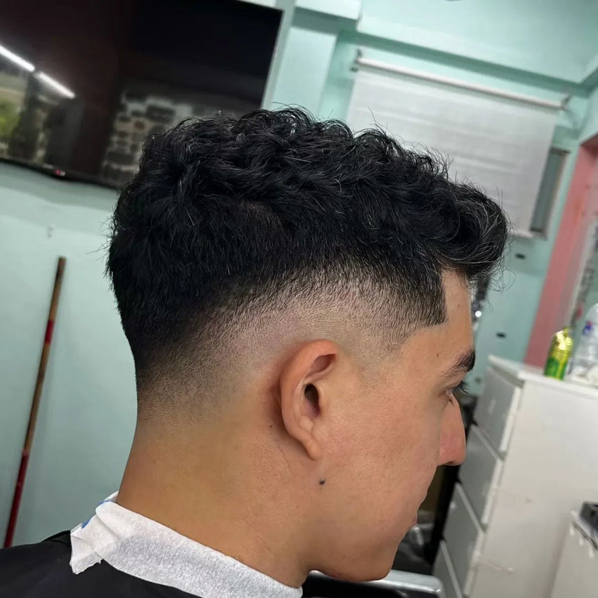 Curly top with a tapered mid fade